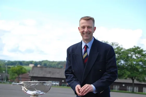 A guest beside one of the silver trophies