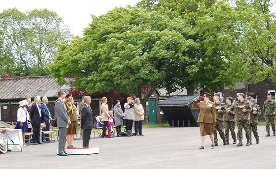 The parade marches past the dais