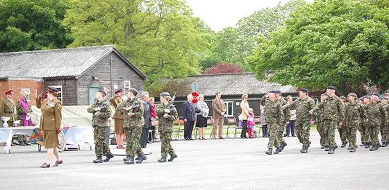 An officer leads the march past